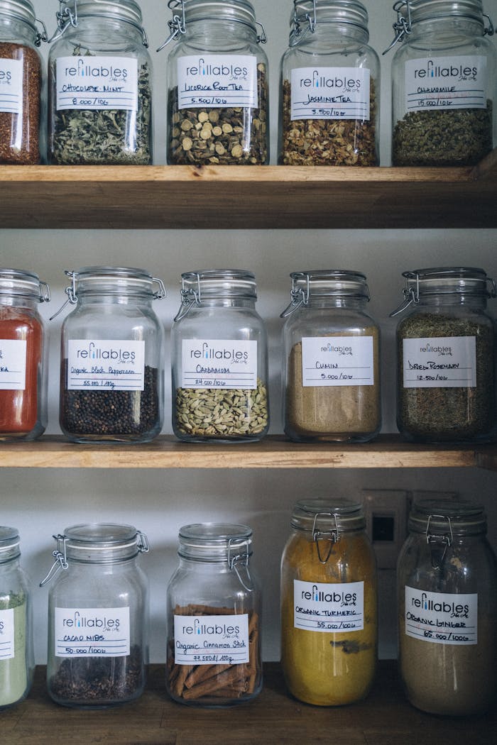 Clear Glass Jars on Brown Wooden Shelves